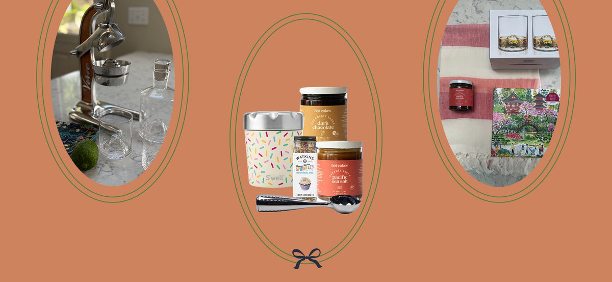 Curated gift bundles featuring cocktail accessories, gourmet treats, a colorful tumbler, and cozy home essentials, displayed on a terracotta background.
